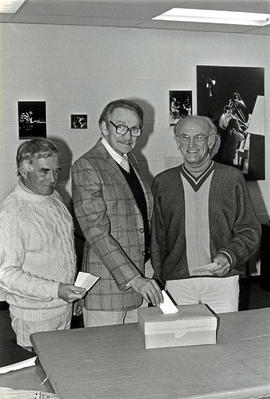 Photograph of Faculty Members Putting Their Vote in a Ballot Box