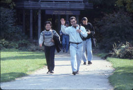 Photograph of Two People Walking Down a Pathway