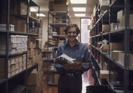 Photograph of an offset operator in the Print shop supply room