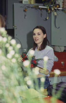 A photograph of a Retail Floriculture student preparing a floral arrangement