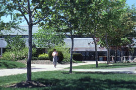 Photograph of a person walking outside the main entrance