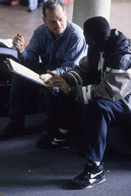 Photograph of Two People Sitting and Talking