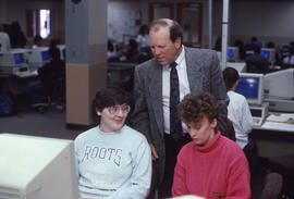 Photograph of instructor Tom Olien and students in a computer lab