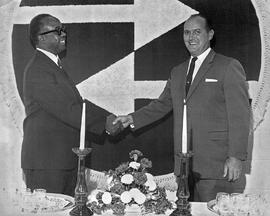 Photograph of Jim Davison Shaking Hands with Milton Cato