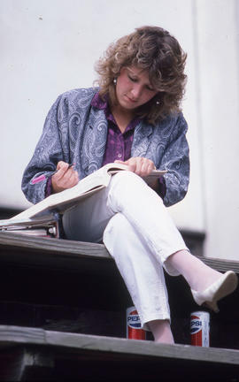 Photograph of a student studying on the landscaped bleachers