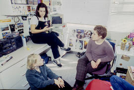 Photograph of students seated in a residence dorm