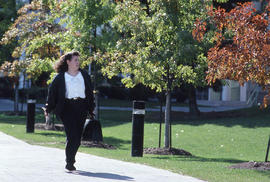 Photograph of a person on the main walkway in front of NX building