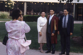 Photograph of parents posing with graduate student