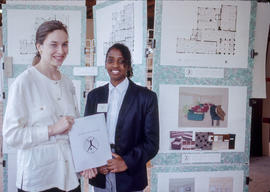 Photograph of two Interior Design students in front of a display