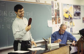 A photograph of and Industrial Design student demonstrating his design