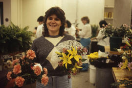 Photograph of a student holding flowers from the Retail Floriculture program