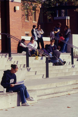 Photograph of students sitting and standing around Lakeshore cottages