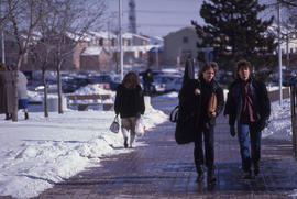 Photograph of students on the walkway to the D building