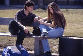 Photograph of Two Students Sitting on a Bench