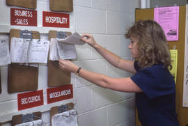 Photograph of an Unknown Person Consulting Work Sheets