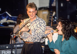 Photograph of music students playing an instrument and singing together