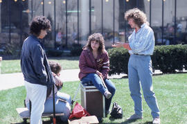 Photograph of students conversing on the lawn