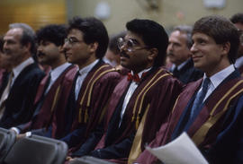 Photograph of staff member and graduates
