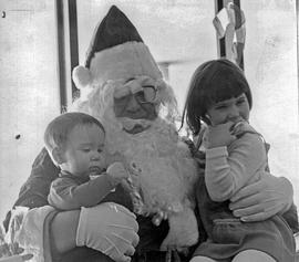 Photograph of Two Daycare Children Sitting on Santa's Lap
