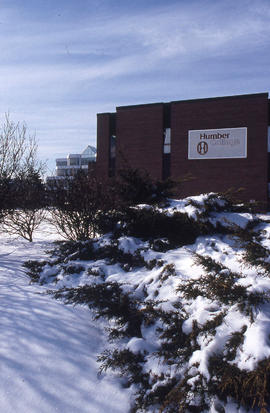 A photograph of building J and, in the background, Building NX
