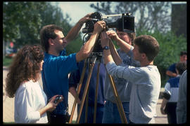 Photograph of Students Working with a Movie Camera on a Tripod Mount