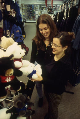 A photograph of two students browsing merchandise in the Bookstore
