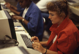 Photograph of a student typing on a computer keyboard