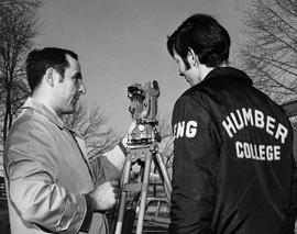 Photograph of Jerry Srom Teaching a Student How To Use Surveying Equipment