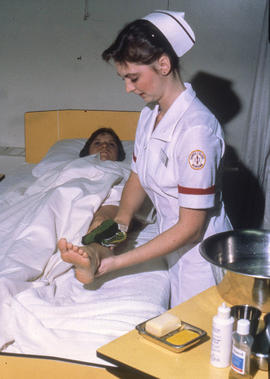 Photograph of a Nursing student practicing how to dress a foot wound