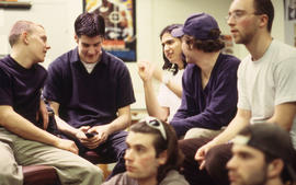 A photograph of Industrial Design students examining a model tv remote control