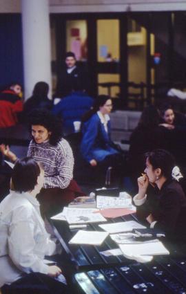 Photograph of students gathered and working on assignments