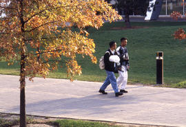 Photograph of students on the main entrance walkway to NX building in the fall