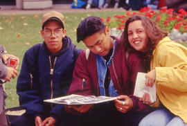 Photograph of students looking through their yearbook