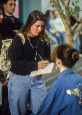 Photograph of a Journalism student interviewing a student