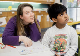 Photograph of an Early Childhood Education student sitting with a child