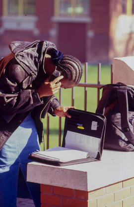 Photograph of student checking information in a binder