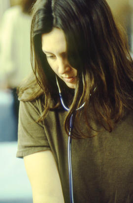 Photograph of nursing students learning to use a stethoscope and blood pressure cuff in the lab