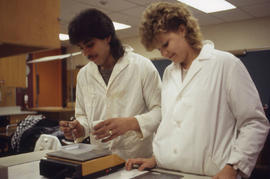 Photograph of Pharmacology students working with a measurement device