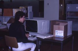 Photograph of an admissions clerk working