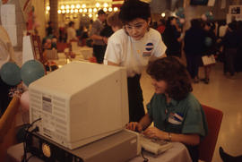 Photograph of two staff checking something on the computer