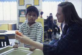 Photograph of an early childhood educator trying to get a child's attention
