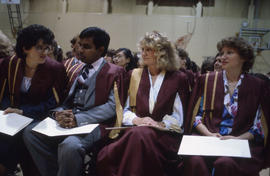 Photograph of graduating students seated with their diplomas