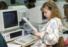 Photograph of a student looking over her assignment