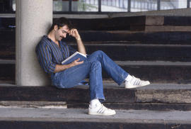 Photograph of a student studying on the bleachers