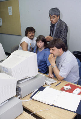 Photograph of students and their instructor in a computer lab