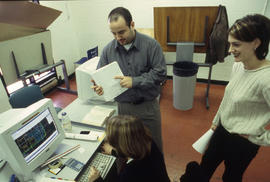 Photograph of students working on an assignment with CAD drawings