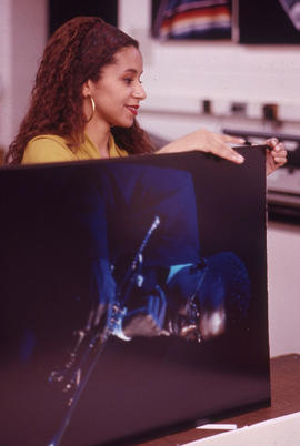 Photograph of a Media Studies student working with oversized prints