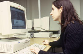 A photograph of a student sitting at a computer in the Technology lab