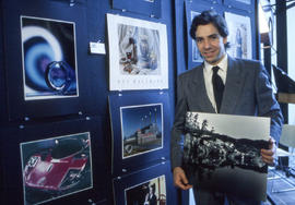 Photograph of a student displaying his photography work at North campus