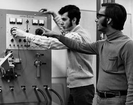 Photograph of Two Students Working with an Electro Fluid Tester